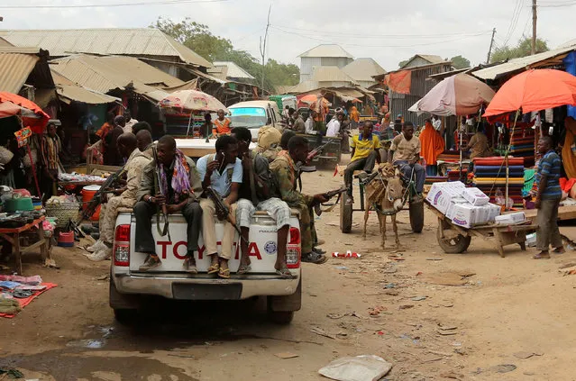 Somali soldiers patrol a street market following a suicide car bomb and gun attack on Tuesday that killed 11 people in Afgoye, Somalia October 19, 2016. (Photo by Feisal Omar/Reuters)