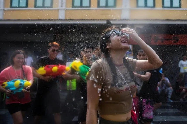 Locals and tourists play with water as they celebrate the Songkran holiday which marks the Thai New Year in Bangkok, Thailand on April 13, 2023. (Photo by Chalinee Thirasupa/Reuters)