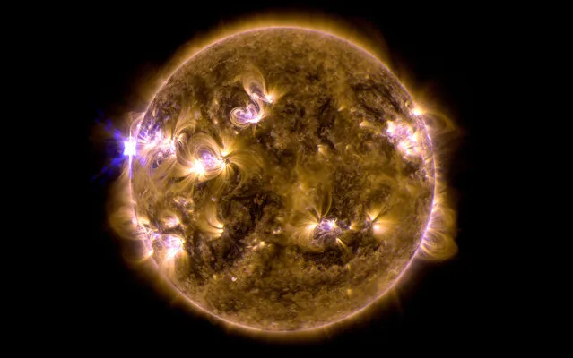 This blend of two images taken by NASA’s Solar Dynamics Observatory shows a solar eruption that occurred on May 12, 2013. One image shows light in the 171-angstrom wavelength, the other in 131 angstroms. Scientists say the Mother’s Day solar flare was the strongest of the year and occurred on the side of the sun that faced away from Earth. (Photo by AP Photo/NASA's Solar Dynamics Observatory)
