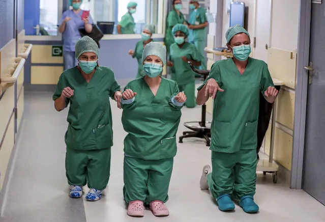 Nurses on their knees conduct a race in the corridors of the COVID-19 unit during a break at the Etterbeek-Ixelles site of the Iris Sud Hospitals in Brussels, Belgium, 24 April 2020, amid the ongoing coronavirus COVID-19 pandemic. Countries worldwide increased their measures to prevent the widespread of the SARS-CoV-2 coronavirus which causes the COVID-19 disease. (Photo by Stephanie Lecocq/EPA/EFE/Rex Features/Shutterstock)