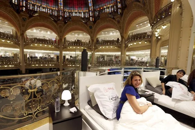 Kareen (L), from France, prepares to sleep overnight in the Galeries Lafayette department store with five other hand-picked shoppers, as part of a special event on the eve of the start of winter sales, in Paris, January 6, 2015. (Photo by Charles Platiau/Reuters)