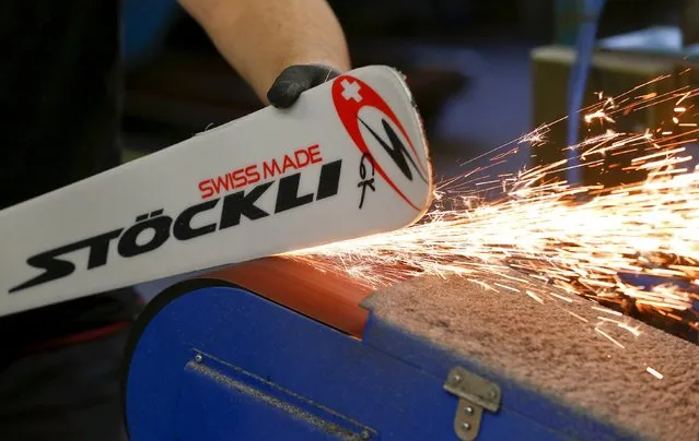 Sparks are thrown as an employee grinds the edges of a ski at the plant of Swiss ski manufacturer Stoeckli in Malters, Switzerland November 25, 2015. (Photo by Arnd Wiegmann/Reuters)