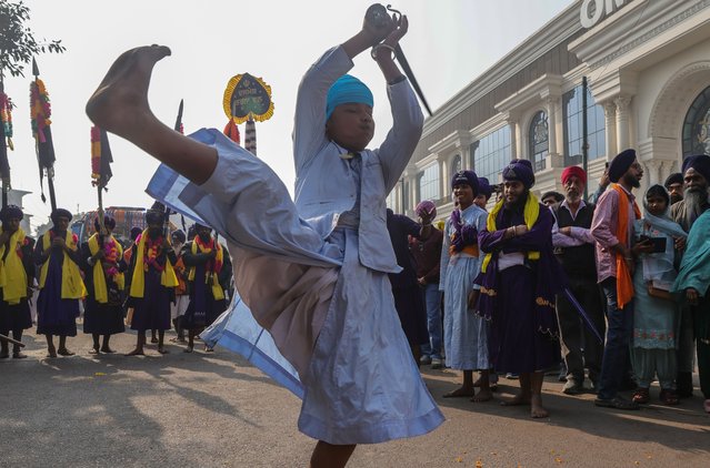 A Nihang Sikh, belonging to the Sikh warrior clan, performs Gatka, a form of Sikh martial arts, during a religious procession marking the 350th martyrdom anniversary of Guru Tegh Bahadur Ji in New Delhi, India, 25 November 2025. The procession commemorates the martyrdom of the 9th Sikh Guru, Sri Guru Tegh Bahadur Ji, who was executed in 1675 AD for refusing to convert to Islam on the orders of Mughal Emperor Aurangzeb. The event is observed at Gurudwara Sis Ganj in Delhi. Guru Tegh Bahadur, the youngest of the five sons of Guru Hargobind, was born in Amritsar in 1621. (Photo by Rajat Gupta/EPA)
