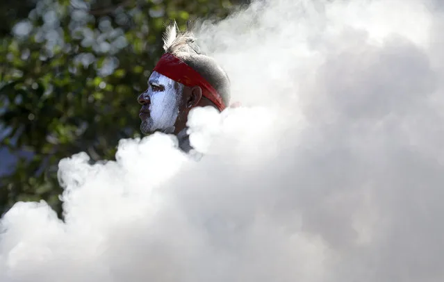 Russell Dawson of the Koomurri Aboriginal Dancers participates in a smoking ceremony during Australia Day ceremonies in Sydney, Tuesday, January 26, 2021. (Photo by Rick Rycroft/AP Photo)