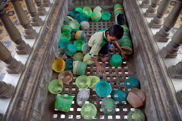 A Muslim boy arranges prayer caps inside a mosque during the holy month of Ramadan in Kolkata, India, June 3, 2018. (Photo by Rupak De Chowdhuri/Reuters)