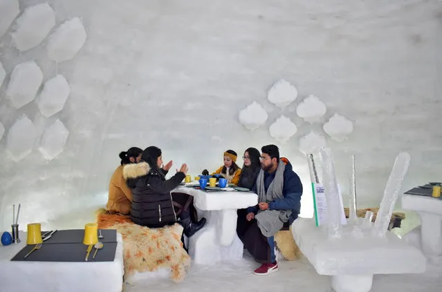 Tourists drink inside “Igloo Cafe”, a cafe prepared with snow and ice, at Gulmarg, a ski resort and one of the main tourist attractions in Kashmir region, January 28, 2021. (Photo by Sanna Irshad Mattoo/Reuters)