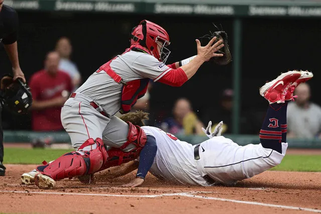 Cleveland Guardians' Josh Naylor scores against Los Angeles Angels catcher Matt Thaiss during the second inning of a baseball game Friday, May 12, 2023, in Cleveland. (Photo by David Dermer/AP Photo)