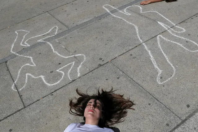 A human rights activist from the Spanish Commission for Refugee Aid (CEAR) protests for the right of asylum for victims of gang violence on World Refugee Day in Madrid, Spain, June 20, 2018. (Photo by Susana Vera/Reuters)