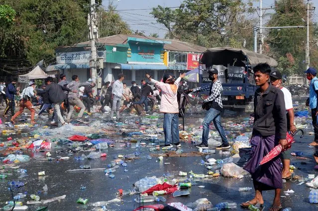 Demonstrators riot against police as they protest against the military coup in Mandalay, Myanmar, February 9, 2021. (Photo by Reuters/Stringer)