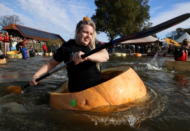 Competitors paddle in giant hollowed out pumpkins at the yearly pumpkin regatta in Kasterlee, Belgium on October 27, 2024. (Photo by Bart Biesemans/Reuters)