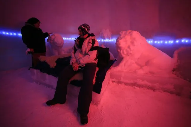 A couple of tourists visit a room inside the Balea Lac Hotel of Ice in the Fagaras mountains January 29, 2015. Entirely made of ice, the hotel offers accommodation in 12 double rooms with king size beds, where the temperature is between -2 and +2 degrees Celsius. (Photo by Radu Sigheti/Reuters)