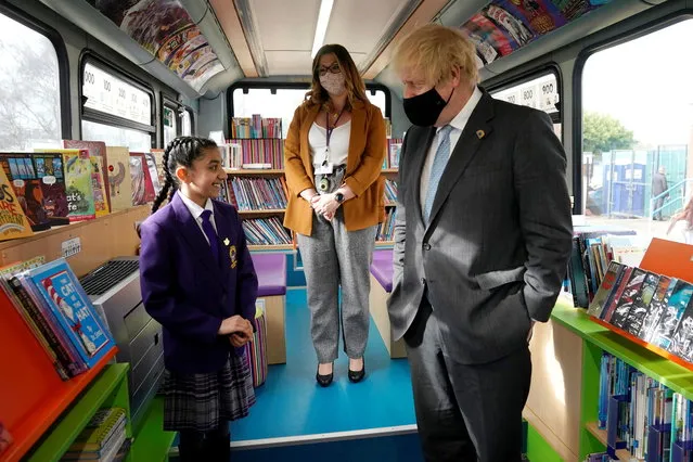 British Prime Minister Boris Johnson speaks with the Head Girl on a bus library during his visit to St Mary's CE Primary School, ahead of reopening of the primary and secondary schools across England planned for March 8, in Stoke-on-Trent, Britain on March 1, 2021. (Photo by Christopher Furlong/Pool via Reuters)