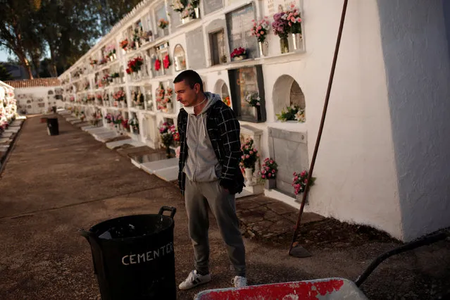 Unemployed David Marquez, 35, stands after exhuming a body from a niche during a practical test to get a job as grave-digger between other 50 aspirants, called by the town hall at the cemetery of San Lorenzo in Ronda, southern Spain, November 16, 2016. (Photo by Jon Nazca/Reuters)