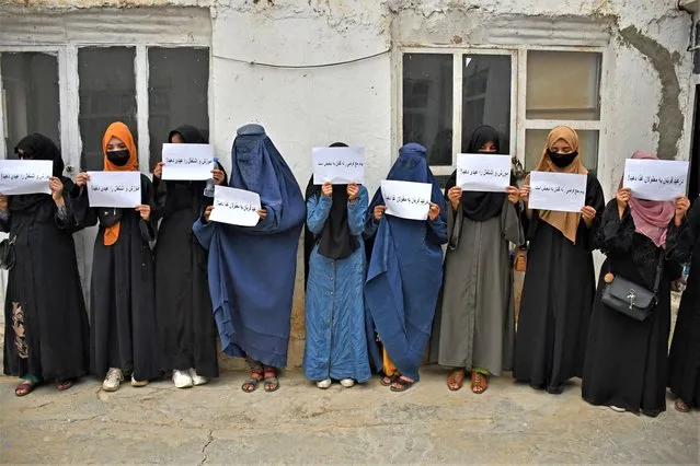 Afghan women hold placards demanding their right to education, in Mazar-i-Sharif on June 26, 2023. (Photo by Atif Aryan/AFP Photo)