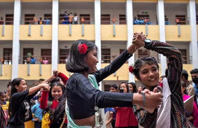 A group of female students perform dance in front of teachers and students while celebrating Teacher's Day, also known as “Guru Purnima” at the Shanti Vidhya School in Kathmandu, Nepal on July 3, 2023. On Teacher's Day, students give gifts to their teachers, who in turn bless their students for a bright future and a good career. (Photo by Narendra Shrestha/EPA)