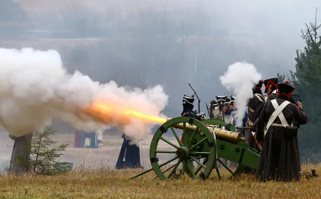 People dressed in the historic uniforms of the Imperial Russian army take part in a re-enactment of the 1812 Battle of Berezina, to mark the 204th anniversary of the battle, near the village of Bryli, Belarus, November 27, 2016. (Photo by Vasily Fedosenko/Reuters)