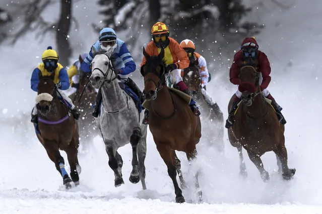 Riders and horses compete during the 2nd Grand Prix “Handels- & Gewerbeverein St. Moritz” on the frozen Lake St. Moritz,  on the first weekend of the White Turf races in St. Moritz, Switzerland, Sunday, February  8, 2015.  (Photo by Gian Ehrenzeller/AP Photo/Keystone)