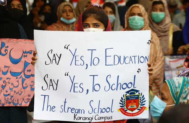 School staff hold placards reading in Urdu “Save Education” during a protest as they demand the government to reopen all educational institutes, amid smart lockdown due to coronavirus pandemic in Karachi, Pakistan, 12 April 2021. Pakistani authorities imposed smart lockdowns in an effort to curb the outbreak of a third wave of infections with Covid-19. (Photo by Shahzaib Akber/EPA/EFE)