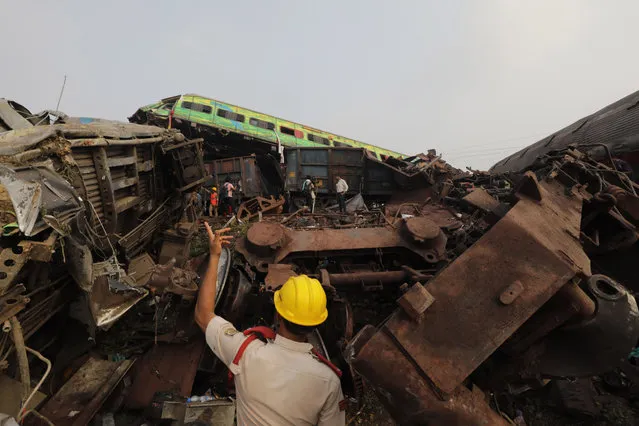 The National Disaster Response Force Rescue continues work at the site of a train accident at Odisha Balasore, India, 03 June 2023. Over 200 people died and more than 900 were injured after three trains collided one after another. According to railway officials the Coromandel Express, which operates between Kolkata and Chennai, crashed into the Howrah Superfast Express. (Photo by Piyal Adhikary/EPA/EFE/Rex Features/Shutterstock)