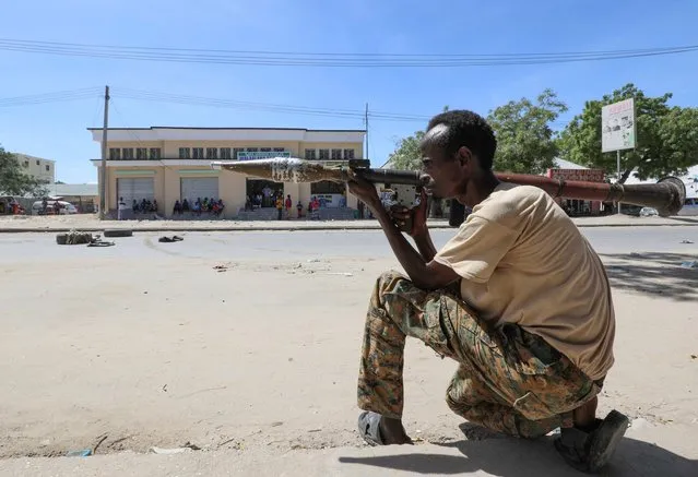 A soldier supporting anti-government opposition groups carries a rocket-propelled grenade launcher on a street in the Fagah area of Mogadishu, Somalia Sunday, April 25, 2021. Gunfire was exchanged Sunday between government forces loyal to President Mohamed Abdullahi Mohamed, who signed into law on April 14 a two year extension of his mandate and that of his government, and other sections of the military opposed to the move and sympathetic to former presidents Hassan Sheikh Mohamud and Sharif Sheikh Ahmed. (Photo by Feisal Omar/Reuters)