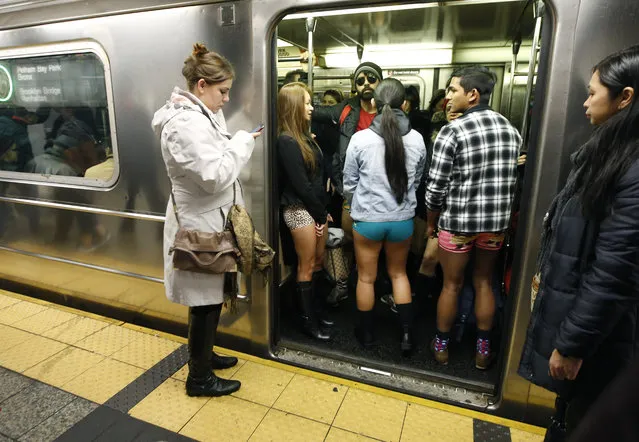 The doors of a subway train open revealing pantless riders in colorful underwear  during the 15th annual No Pants Subway Ride Sunday, January 10, 2016, in New York. (Photo by Kathy Willens/AP Photo)