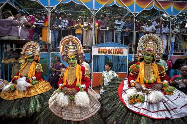 Artists wait to participate in a procession marking 'Atham', the first day of ten-days long Onam festival in Kochi, Kerala state, India, Sunday, August 20, 2023. (Photo by R.S. Iyer/AP Photo)