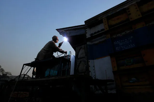 A man welds a truck at a vehicle workshop in Rawalpind, Pakistan, November 10, 2016. (Photo by Faisal Mahmood/Reuters)