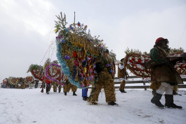 Participants, dressed in costumes, walk to visit local houses during the celebrations for Malanka holiday in the village of Krasnoilsk in Chernivtsi region, Ukraine, January 14, 2016. (Photo by Valentyn Ogirenko/Reuters)