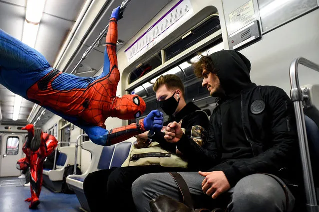 Underground dancers dressed in Spiderman costumes  perform in the subway of Saint Petersburg late on May 21, 2021. (Photo by Olga Maltseva/AFP Photo)