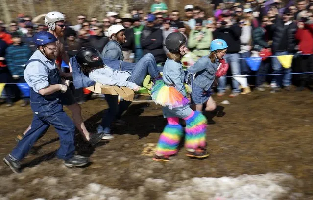 A team carrying a mock coffin runs around the muddy track in the Coffin Races at Frozen Dead Guy Days in Nederland, Colorado March 14, 2015. (Photo by Rick Wilking/Reuters)
