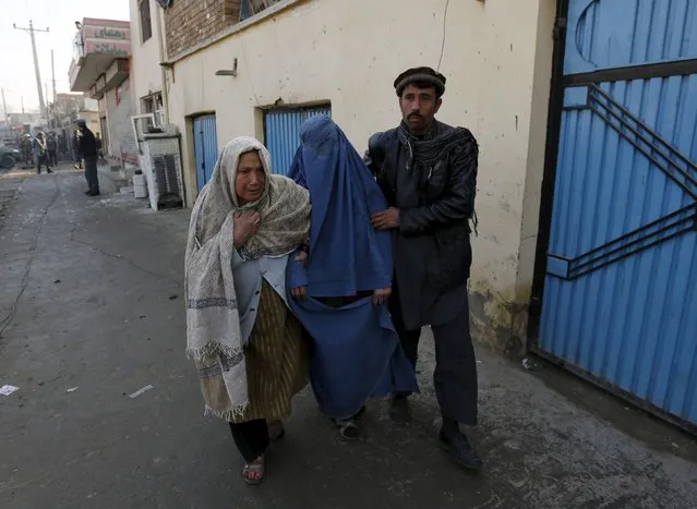 An injured Afghan woman is assisted by her relatives after she was wounded by a suicide attack Kabul, Afghanistan, December 28, 2015. A suicide bomber killed at least one person and wounded 13 in an attack on a road near Kabul airport, officials in the Afghan capital said on Monday, barely two weeks after a major Taliban assault in the city. (Photo by Mohammad Ismail/Reuters)