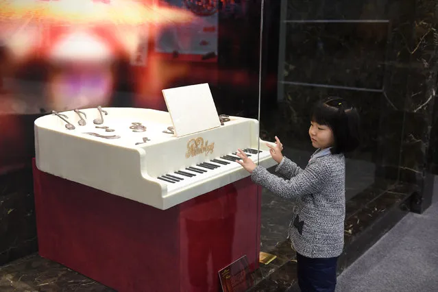 A girl visits a chocolate art exhibition at the Museum of the Imperial Palace of “Manchukuo” in Changchun, Jilin province, China December 14, 2016. (Photo by Reuters/Stringer)
