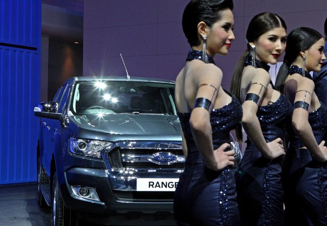 Models stand before the New Ford Ranger car during the Global Reveal at the 36th Bangkok Internatonal Motor Show in Bangkok, Thailand, March 23, 2015. (Photo by Jurnasyanto Sukarno/JG Photo)