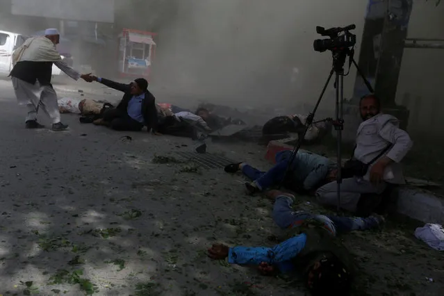 Afghan journalists are seen after a second blast in Kabul, Afghanistan, April 30, 2018. The explosion killed nine reporters, photographers and cameramen covering the attack. (Photo by Omar Sobhani/Reuters)