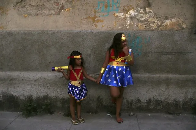 Girls dressed as Wonder Woman attend an annual block party known as “Cordao de Prata Preta”, one of the many carnival parties to take place in the neighbourhoods of Rio de Janeiro, February 6, 2016. (Photo by Pilar Olivares/Reuters)