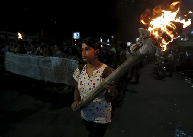 A student holds a torch during a rally to protest against the arrest of a student of Jawaharlal Nehru University (JNU), outside the Jadavpur University campus in Kolkata, India, February 16, 2016. (Photo by Rupak De Chowdhuri/Reuters)