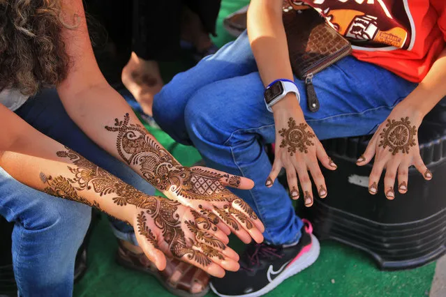 Women applying “Henna” on their hands on the occasion of “Sinjara” festival, ahead of Teej, in Jaipur, Rajasthan, India, on August 10, 2021. (Photo by Vishal Bhatnagar/NurPhoto/Rex Features/Shutterstock)