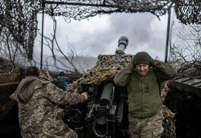 Ukrainian service members fire a L119 howitzer towards Russian troops near the front line town of Bakhmut, amid Russia's attack on Ukraine, in Donetsk region, Ukraine on December 21, 2023. (Photo by Viacheslav Ratynskyi/Reuters)