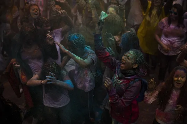 Revelers shout and throw coloured powder during a Holi Festival in Madrid, Spain, Sunday, April 26, 2015. (Photo by Andres Kudacki/AP Photo)