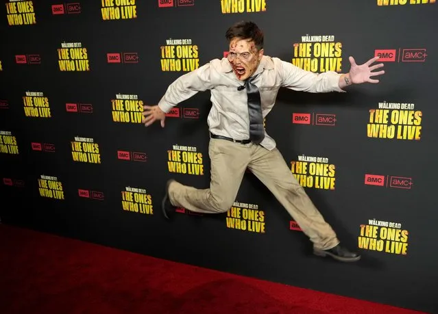 Actor Kurt Tocci leaps for photographers at the premiere of the AMC series “The Walking Dead: The Ones Who Live”, Wednesday, February 7, 2024, in Los Angeles. (Photo by Chris Pizzello/AP Photo)