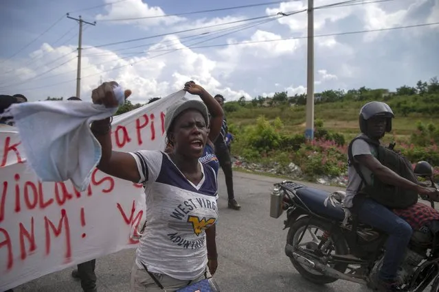 People protest for the release of the kidnapped missionaries near the missionaries' headquarters in Titanyen, north of Port-au-Prince, Haiti, Tuesday, October 19, 2021. (Photo by Joseph Odelyn/AP Photo)