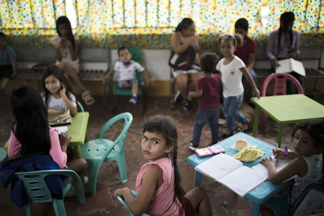 Venezuelan kindergartners attend free classes at Happy Children's, a school for Venezuelan migrant children, in La Parada, near Cucuta, Colombia, Wednesday, October 6, 2021. Venezuela partially reopened its border with Colombia after closing it on 2019, a nearly three-year closure due to political tensions. (Photo by Ivan Valencia/AP Photo)