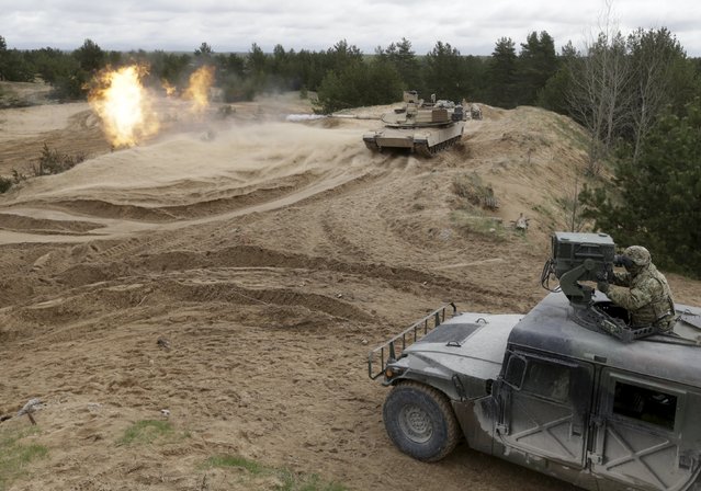 U.S. soldiers of the 2nd Battalion, 7th Infantry Regiment, “Cottonbalers”, who are deployed in Latvia, take part in a training exercise with M1A2 “Abrams” tank in Adazi military base, Latvia, May 7, 2015. (Photo by Ints Kalnins/Reuters)