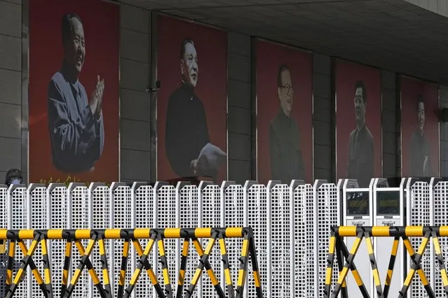 Portraits of China's former top leaders from left Mao Zedong, Deng Xiaoping, Jiang Zemin, Hu Jintao and including the current President Xi Jinping are seen at a military camp in Beijing, China, Thursday, November 11, 2021. China's leaders have approved a resolution on the history of the ruling Communist Party that was expected to set the stage for President Xi Jinping to extend his rule next year during a four-day meeting of its Central Committee that ended Thursday. (Photo by Ng Han Guan/AP Photo)