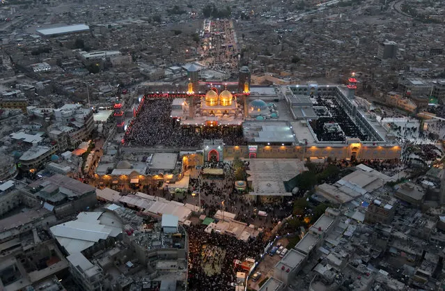 An aerial view of the holy Muslim Shiite shrine of Imam Moussa al-Kazim as pilgrims gather to commemorate his death, in the Shiite district of Kazimiyah, Baghdad, Iraq, Wednesday, May 13, 2015. (Photo by Hadi Mizban/AP Photo)