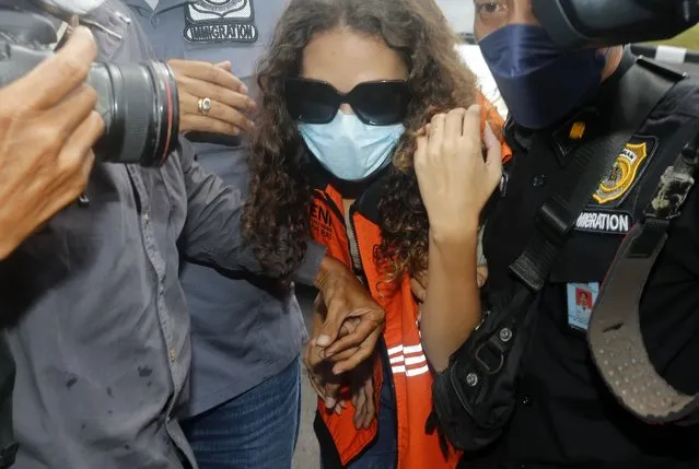 Heather Mack of Chicago, Ill., center, escorted by Indonesian immigration officers to Immigration detention center in Jimbaran, Bali, Indonesia on Friday, October 29, 2021. The American woman convicted of helping to kill her mother on Indonesia's tourist island of Bali in 2014 walked free from prison Friday after serving seven years of a 10-year sentence and will be deported to the United States. (Photo by Firdia Lisnawati/AP Photo)