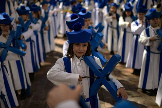 Young devotes take part during Palm Sunday in Zaragoza, northern Spain, Sunday, March 24, 2024. Hundreds of processions will be take place throughout Spain during the Easter Holy Week. (Photo by Alvaro Barrientos/AP Photo)
