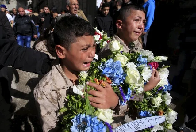 Boys react during the funeral of Fathi Zaydan, a Fatah official responsible for the Palestinian camp of Mieh Mieh, after an explosion that killed him yesterday, during his funeral in Mieh Mieh Palestinian refugee camp, near the port-city of Sidon, Lebanon, April 13, 2016. (Photo by Ali Hashisho/Reuters)