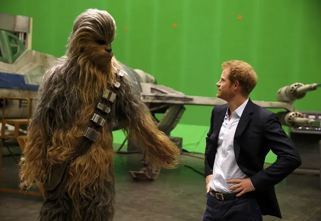 Britain's Prince Harry meets Chewbacca during a visit to the Star Wars film set at Pinewood Studios near Iver Heath, west of London, Britain, April 19, 2016. (Photo by Adrian Dennis/Reuters)