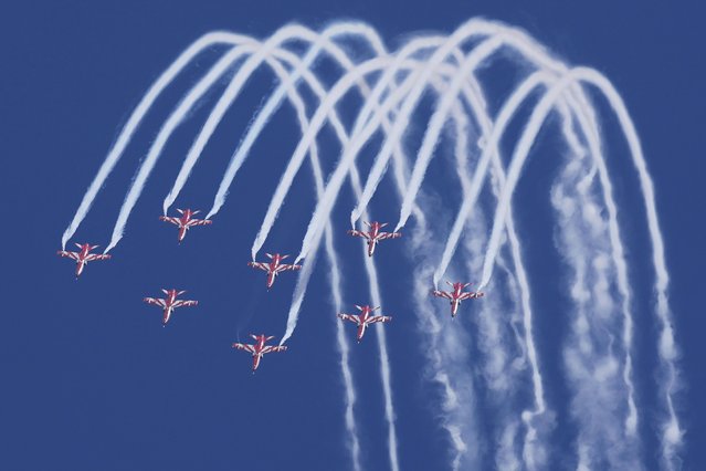 Indian Air Force Suryakiran aircraft perform aerobatic maneuvers during rehearsals ahead of the Aero India 2023 at Yelahanka air base in Bengaluru, India, Saturday, February 11, 2023. Aviation companies from around the world are expected to participate in the five-day event that starts Feb. 13. (Photo by Aijaz Rahi/AP Photo)